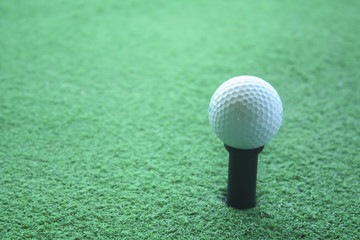 Golf ball on tee ready to be shot at a drivingrange