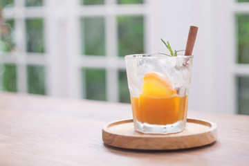 Black coffee with lemon on the wood background