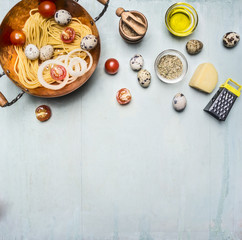 concept cooking homemade vegetarian pasta with cherry tomatoes, parmesan cheese, quail eggs and seasonings, pasta in a copper bowl with the other ingredients, Border, place for text
