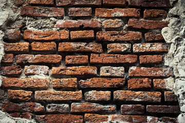 Naklejka premium Old brick wall, old texture of red stone blocks closeup