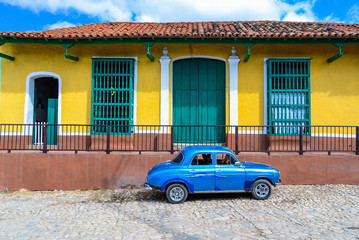 Vintage car and colorful house in Trinidad,Cuba