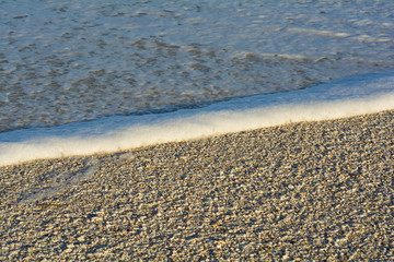 sandy beach with low tidel rolling in 