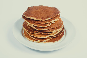 A stack of plain pancakes on a white plate background. isolated