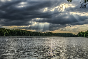 sun through clouds and pond