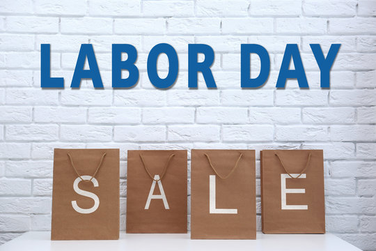 Recycled paper shopping bags on brick wall background