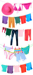 Different clothes hanging from clotheslines on white background
