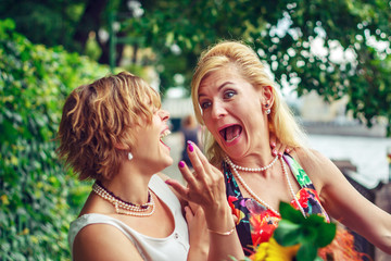 Two girlfriends are having fun in the city park.