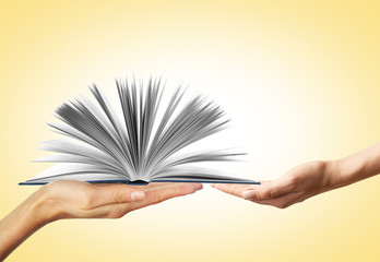 Concept of right to education. Female hands with book on color background