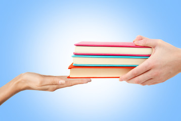 Female hand holding books, isolated on white