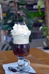 Viennese coffee with whipped cream on glass cup.