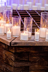 Candles in glass candleholders burning with soft, warm flame