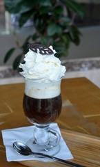 Viennese coffee with whipped cream on glass cup.