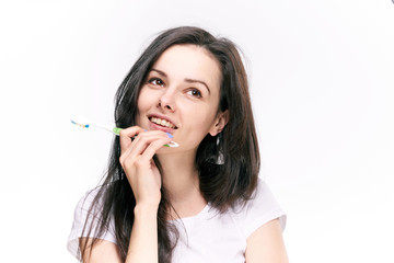 Woman dreaming, woman with toothbrush on isolated background portrait