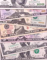 American dollar bills of different denominations abstract background.