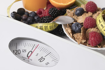 scale with fruit and tape measure, concept of diet