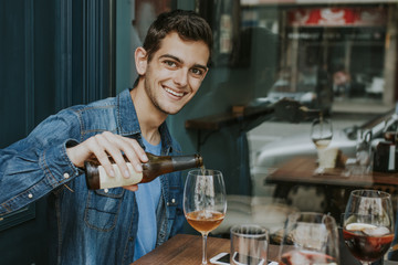 young man on the terrace of the bar drinking beer