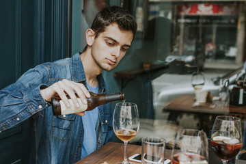 young man on the terrace of the bar drinking beer