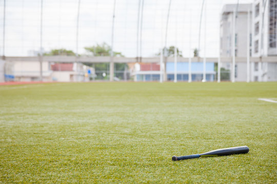 bat for softball on grass field 