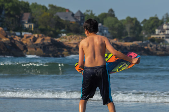 Young boy ready the launch surfboard in waves