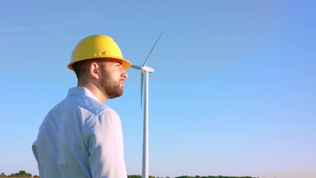The engineer looks at the windmills