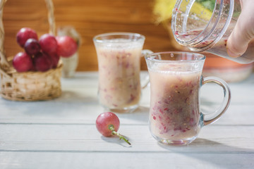 Grape smoothie over the white table.