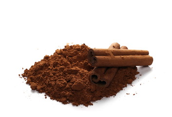 cinnamon sticks and pile cocoa powder isolated on white background