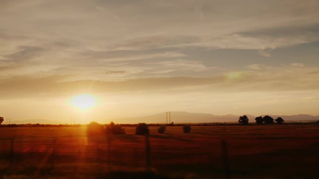 Picturesque countryside at sunset. Fields and vineyards in Europe, view from the car window. ProRes 10 bit video