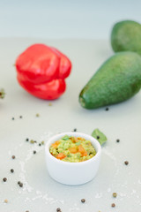 Traditional mexican avocado - vegetarian dip surrounded by its ingredients.