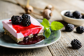 Delicious poppy seed and blackberry cheesecake topped with blackberry sauce