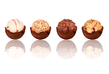 Set of sweets in chocolate with reflection, on white background