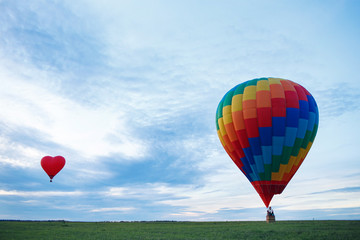 Obraz premium Colorful hot air balloon is flying at sunrise
