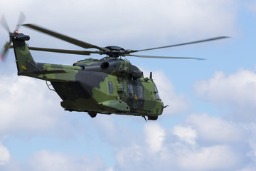 Fototapeta na wymiar Modern tactical helicopter flying away.