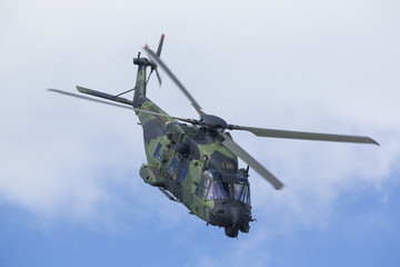 Modern tactical helicopter flying close.