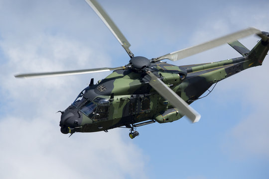 Modern tactical helicopter flying close.