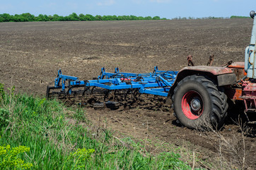Plow attached to a tractor