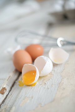 Cracked Egg on White Wooden Table