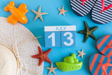 July 13th. Image of july 13 calendar with summer beach accessories and traveler outfit on background. Summer day, Vacation concept