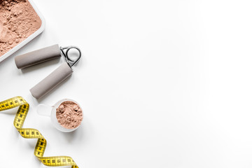 sport diet nutrition and fitness equipment , bars and measure tape white background top view mock up