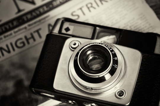 Old vintage retro camera with mocked up newspaper