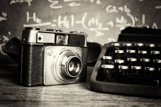 Old vintage retro camera with old-fashioned typewriter