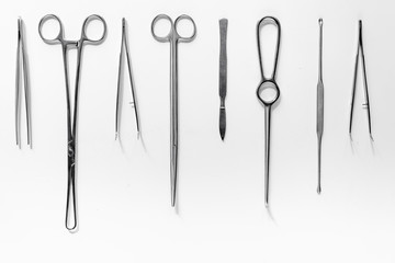 Medical instruments for plastic surgery on white backgrond top view copyspace