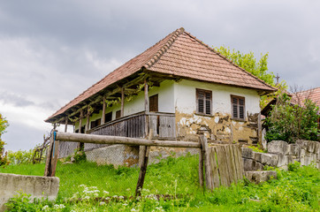 Fototapeta na wymiar Traditional abandoned transylvanian adobe house in a rural area with a sad degrading look