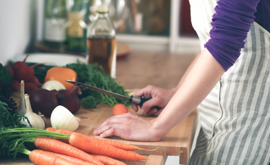 A young woman doing prep in the kitchen.
