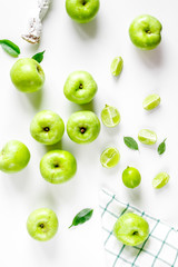 Fototapeta na wymiar natural food design with green apples white desk background top view