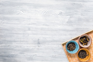 Different kinds of herbal tea on wooden background top view mockup