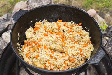 Uzbek national dish pilaf rice in a cast iron cauldron