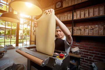 Female cook rolling dough