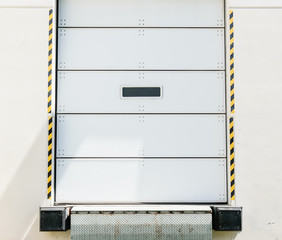 Receiving loading dock door and pull up area