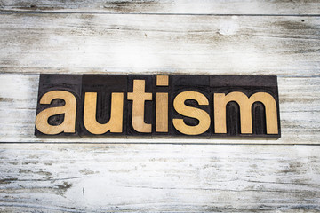Autism Letterpress Word on Wooden Background