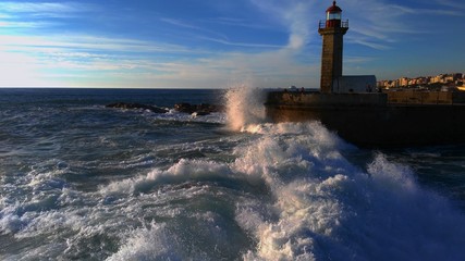 Farol de Felgueiras lighthouse with crashing waves in Oporto, Porto, Portugal